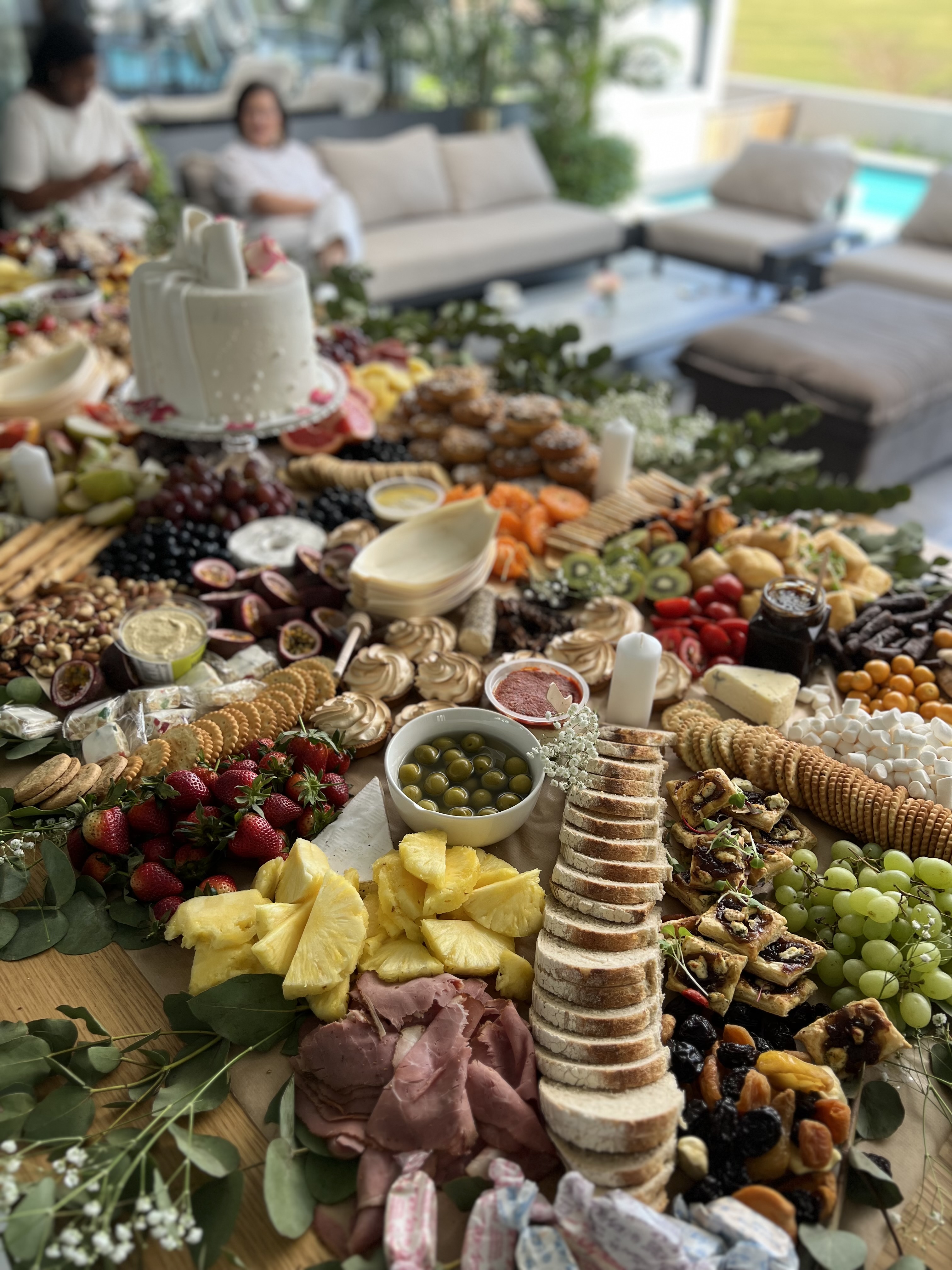 A grazing table beside a pool